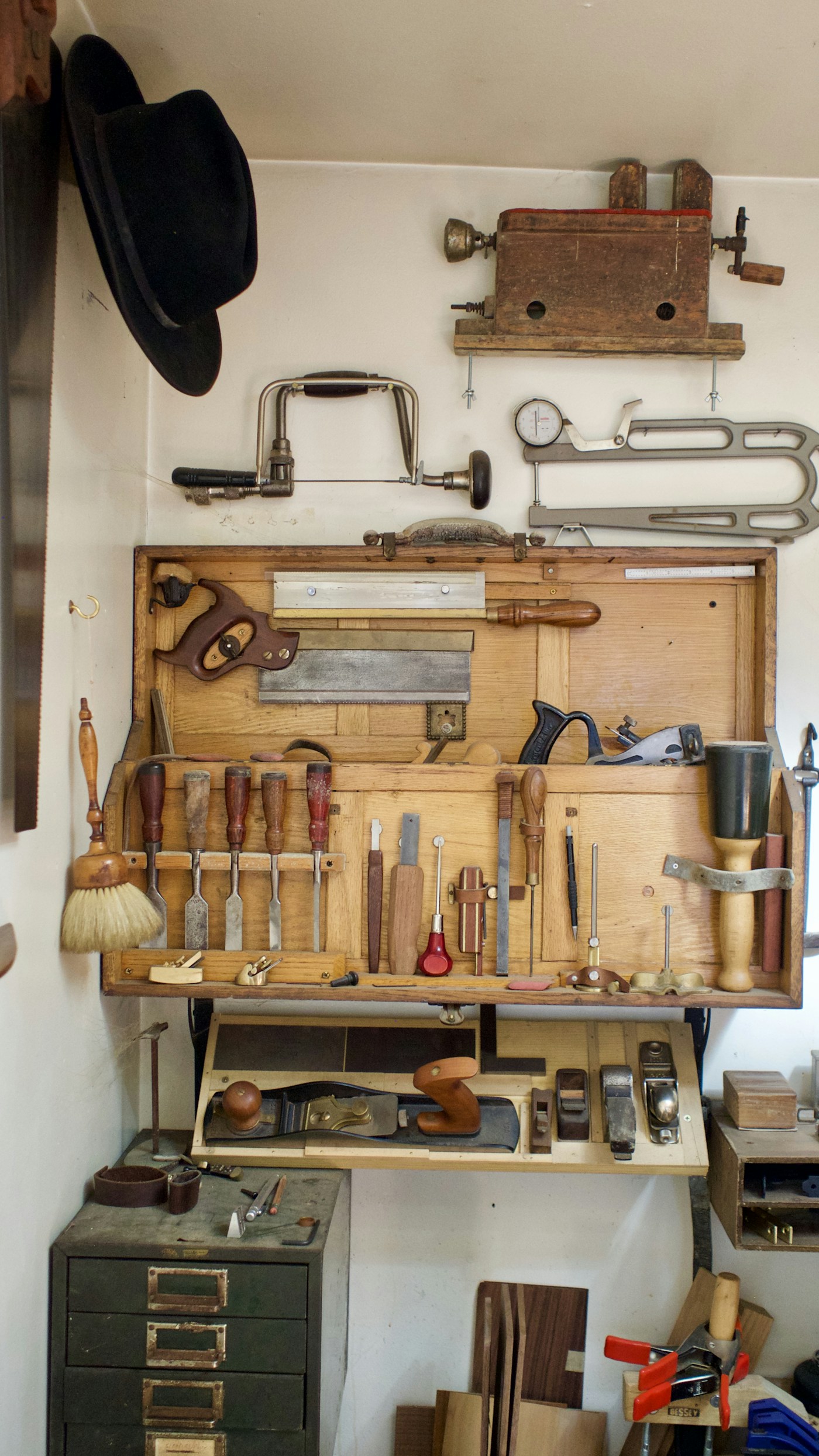 Traditional woodworking tools arranged on a wooden workbench